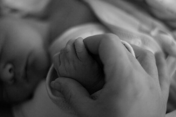holding-hands-with-a-newborn-baby