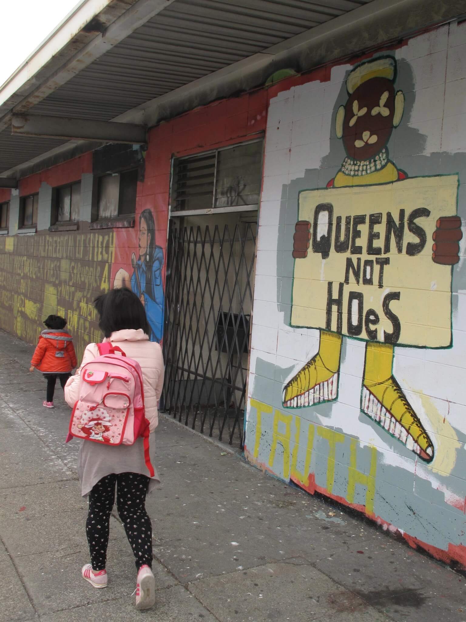 A mother walks her daughter to school down A mother walks her daughter to school down