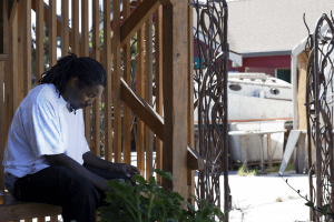 Rosevelt Jones smokes a cigarette outside of Waterside Workshops