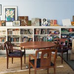 Wooden table and chairs. Book cases.