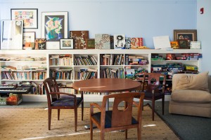 Wooden table and chairs. Book cases.