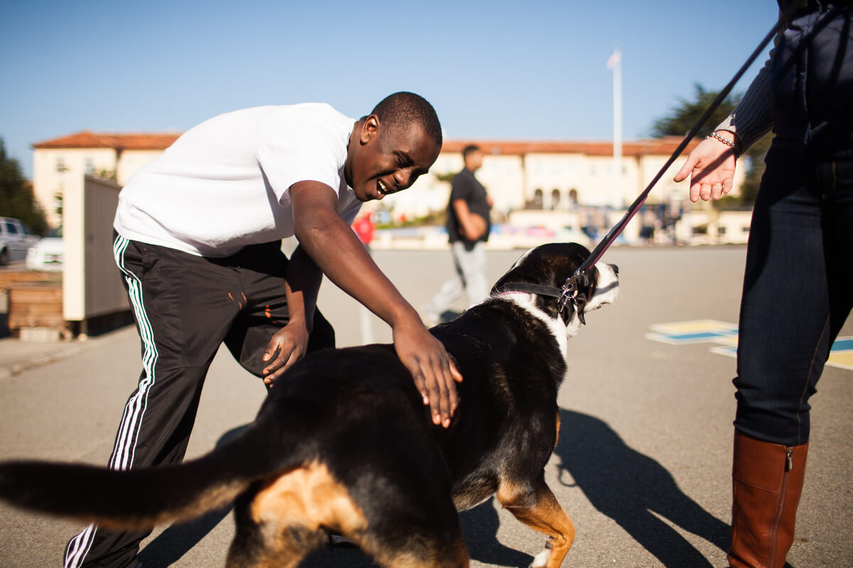 Greg Johnson pets a dog outside