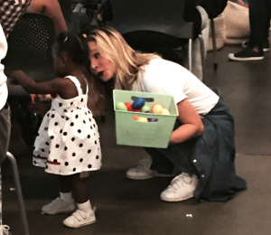 Actress Kristen Bell passing around shakers during the Welcome Reception at the event.