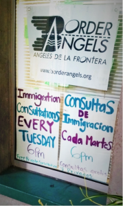 Signs hanging on the window of the Border Angels office.