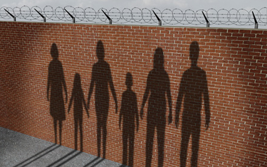 A wall with shadows depicts the separation of immigrant families