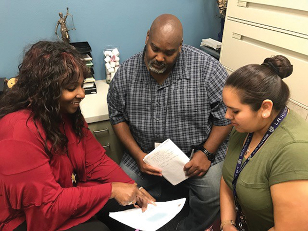 Johnson with DCFS supervisor LaDana Frazier (left) and emergency response social worker Cynthia Ortiz (right). Photo courtesy of DCFS.