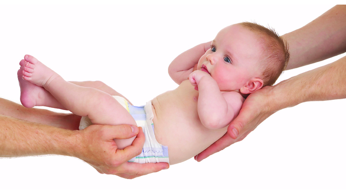 a baby is handed off from one person to another