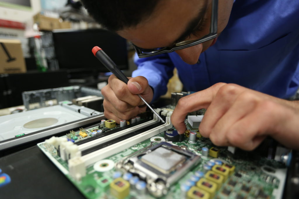 Ricardo Rodriguez works on fixing the motherboard of a computer at the San Diego Futures Foundation.