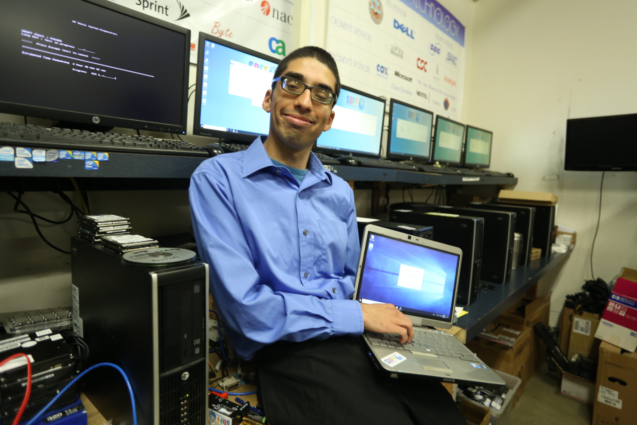 Ricardo Rodriguez at the San Diego Futures Foundation, where he volunteers weekly by fixing computers.