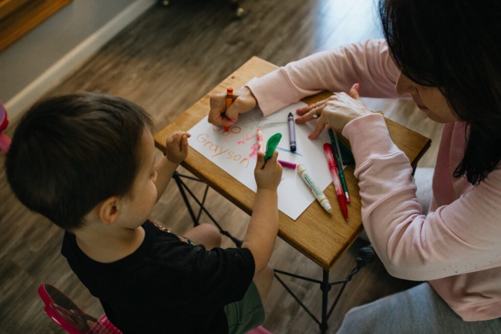 Foster family coloring, with young child on the left and parent on the right.