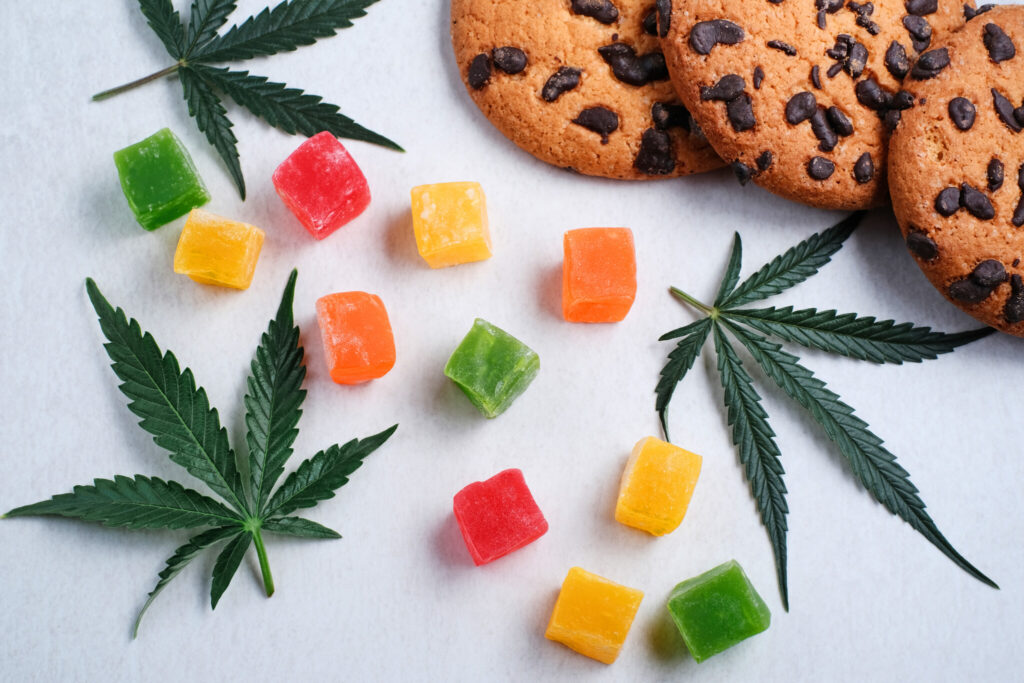 Cannabis leaves, gummies and cookies displayed.